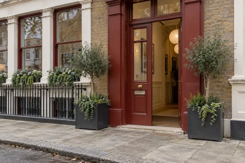 Illustration: Fictional London brick property with a muted-red painted entrance
